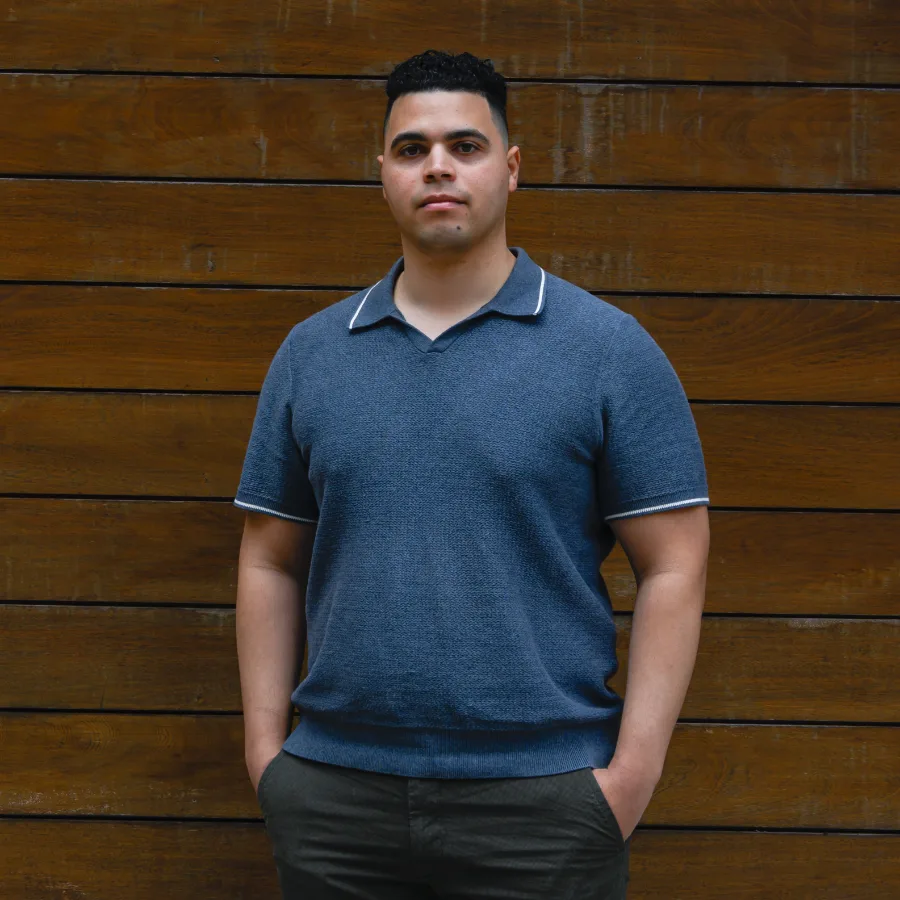 Victor - Portrait against a horizontal wood wall, looking straight at the camera
