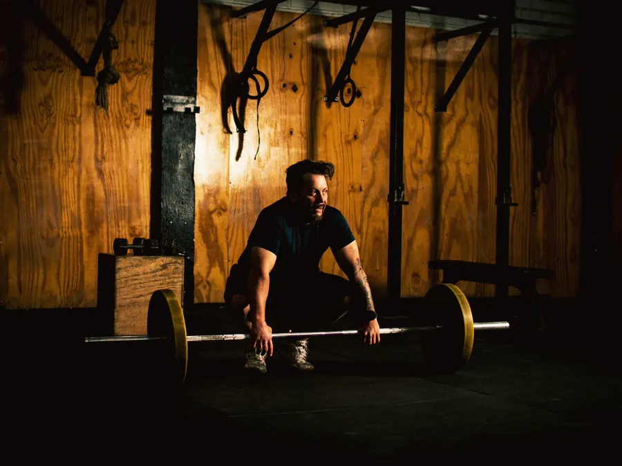 An athlete mid-lift in a strength gym