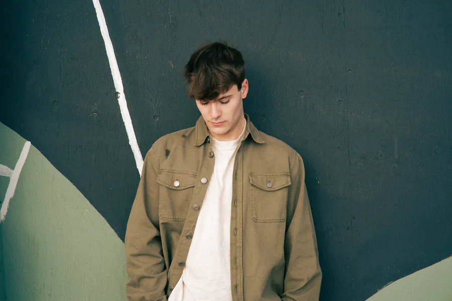 Against a dark green wall