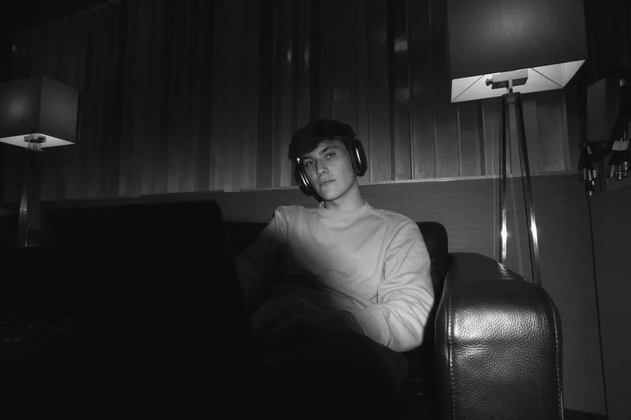Jack Sisk in a studio armchair, black and white